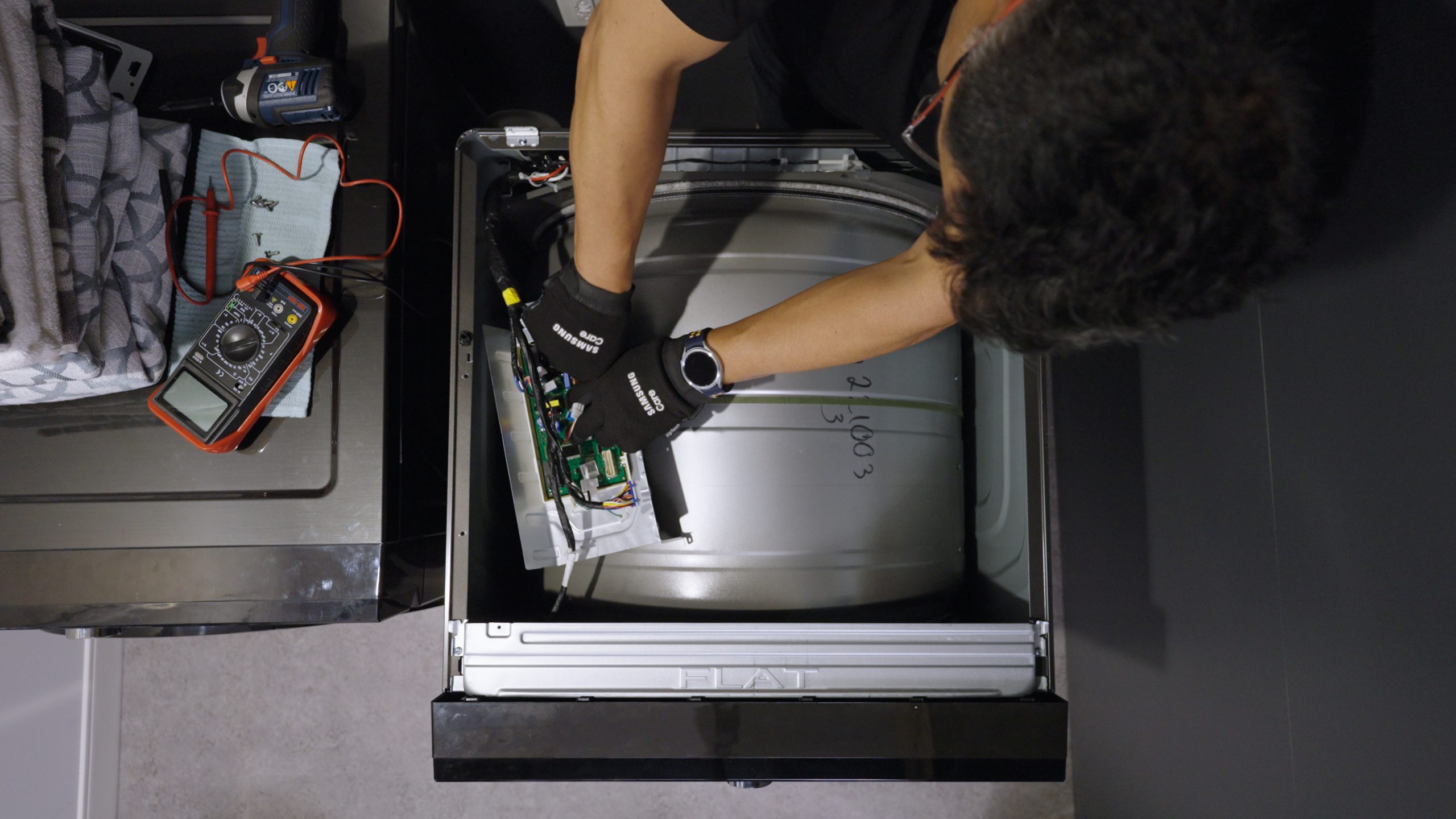 overhead view of Samsung Care technician fixing a machine